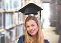 Student woman in education library with graduation hat Royalty Free Stock Photo