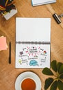 Table top with a notebook with web graphics Royalty Free Stock Photo