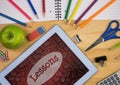 Tablet on a school table with school icons on screen Royalty Free Stock Photo