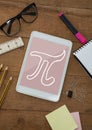 Tablet on a school table with school icons on screen Royalty Free Stock Photo