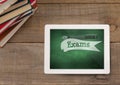 Tablet on a school table with school icons on screen Royalty Free Stock Photo