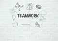 Teamwork text graphics on brick wall