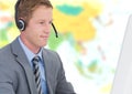 Travel agent man wearing headset in front of world map Royalty Free Stock Photo