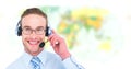 Travel agent man wearing headset in front of world map Royalty Free Stock Photo