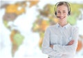 Travel agent woman wearing headset in front of world map Royalty Free Stock Photo