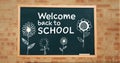 Welcome back to school text and flowers on blackboard