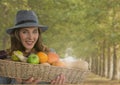 Woman in Autumn with basket of fruit in forest Royalty Free Stock Photo