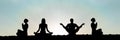 yoga group silhouette at sunset praying Royalty Free Stock Photo