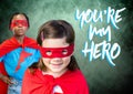 You`re my hero text with Superhero kids in front of green background