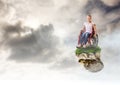 Young Girl on floating rock platform in sky in wheelchair Royalty Free Stock Photo