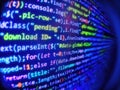 Digital computer code and black background. Programming text on dark screen. Coded data on monitor. Blurred screen with selective Royalty Free Stock Photo