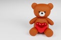 Digital 3D render of a cute romantic brown teddy bear figure with a heart on a white background