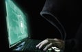 Digital data security system and protection. Anonymous hacker try to hacking on computer laptop Royalty Free Stock Photo