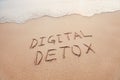 Digital detox concept, words written on the sand outdoor Royalty Free Stock Photo