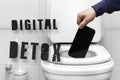 Digital detox inscription, refusal of the phone. a man's hand throws the phone into the toilet because of a breakdown or Royalty Free Stock Photo