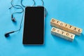 smartphone, earphones and digital detox words Royalty Free Stock Photo