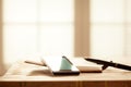 Digital Devices on Wooden Table, Blurred windows background, Smartphone with Note Book and Pen