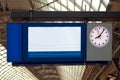 Digital display at train station platform with clock Royalty Free Stock Photo