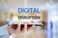 Digital disruption concept, Hand holding smartphone and digital disruption word over blur background, digital innovation and Royalty Free Stock Photo