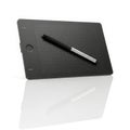 Digital drawing tablet and stylus on a reflective surface Royalty Free Stock Photo