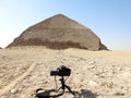 A digital DSLR camera on a tripod Photographing the Bent Pyramid of king Sneferu, A unique example of early pyramid development in