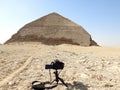 A digital DSLR camera on a tripod Photographing the Bent Pyramid of king Sneferu, A unique example of early pyramid development in