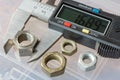 Digital electronic caliper with used nuts on a background of storage box Royalty Free Stock Photo