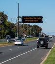 Digital electronic mobile road warning sign that says Hurricane Season prepare now, over a busy highway.