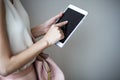 Digital electronic tablet on a woman`s hands. Leather light pink handbag, summer elegant style