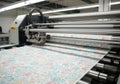 Digital fabric printing machine in action, showcasing vibrant floral patterns on roll-to-roll fabric, emphasizing modern textile Royalty Free Stock Photo