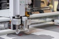 Digital flatbed cutter, plotter cutting white cardboard sheet at exhibition Royalty Free Stock Photo