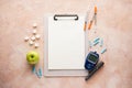 Digital glucometer, lancet pen, apple and syringes on a beige background, flat lay. Diabetes concept. Blood glucose meter