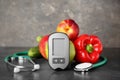 Digital glucometer, stethoscope, fruits