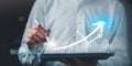 Digital growth analytics concept with hands using tablet, data visualization, bar charts, upward arrow. Represents performance Royalty Free Stock Photo