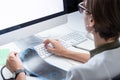 Digital health concept: young medical doctor working at a desktop computer. Female practitioner at modern medical doctor office e