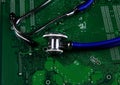 Digital health patient data storage concept - Isolated blue stethoscope on green computer circuit board Royalty Free Stock Photo