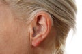 Digital hearing aid in woman`s ear Royalty Free Stock Photo