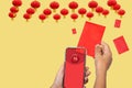 The digital hongbao in chinese new year. .distribute money to family. Translate the Chinese alphabet Fu on cellphone meaning good