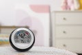 Digital hygrometer with thermometer on mat in room. Space for text Royalty Free Stock Photo