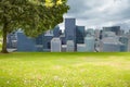 Digital image of grassy landscape with tree and buildings Royalty Free Stock Photo