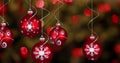 Digital image of red christmas bauble decorations hanging against spots of lights flickering Royalty Free Stock Photo