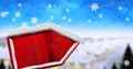 Digital image of snow falling over red wooden sign posts against winter landscape Royalty Free Stock Photo