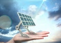 Digital image of solar panel on hand against sky