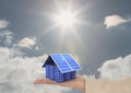 Digital image of solar panels on hand against sky