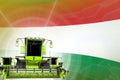 Digital industrial 3D illustration of green modern grain combine harvesters on Hungary flag, farming equipment modernisation