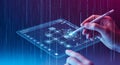 Digital interface interaction: hand uses stylus on futuristic tablet displaying flowchart Royalty Free Stock Photo