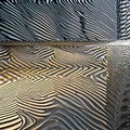 A digital interpretation of a metallic surface, with intricate patterns and reflections of light1, Generative AI