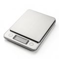Digital kitchen scale with sleek surface on white background Royalty Free Stock Photo
