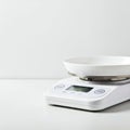 Digital kitchen scale with a sleek white design. It features a round weighing platform and Royalty Free Stock Photo