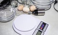 Digital kitchen scales and bowls on a white table Royalty Free Stock Photo